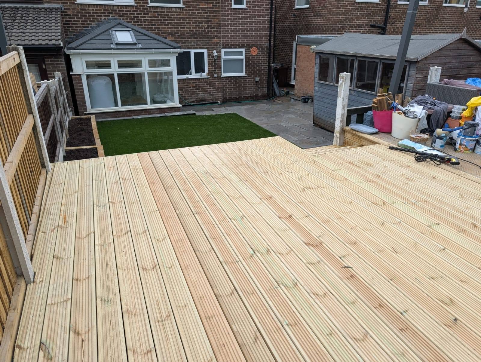 Timber decking under construction overlooking a tiered garden