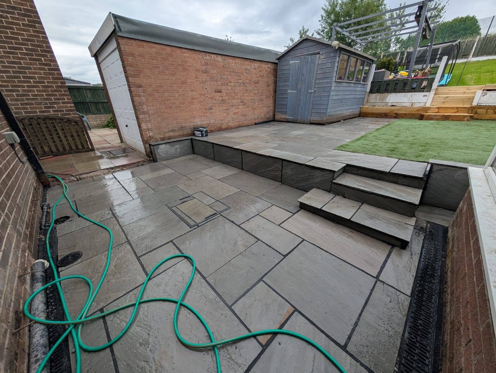 Multi-tiered stone patio with integrated steps