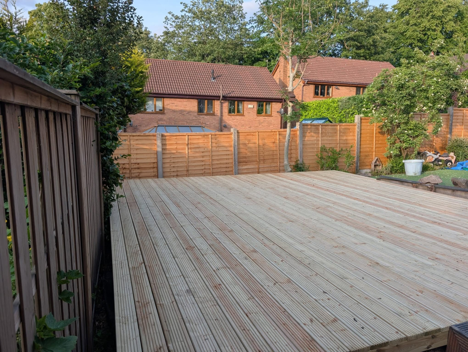 Elevated timber decking platform in a residential back garden